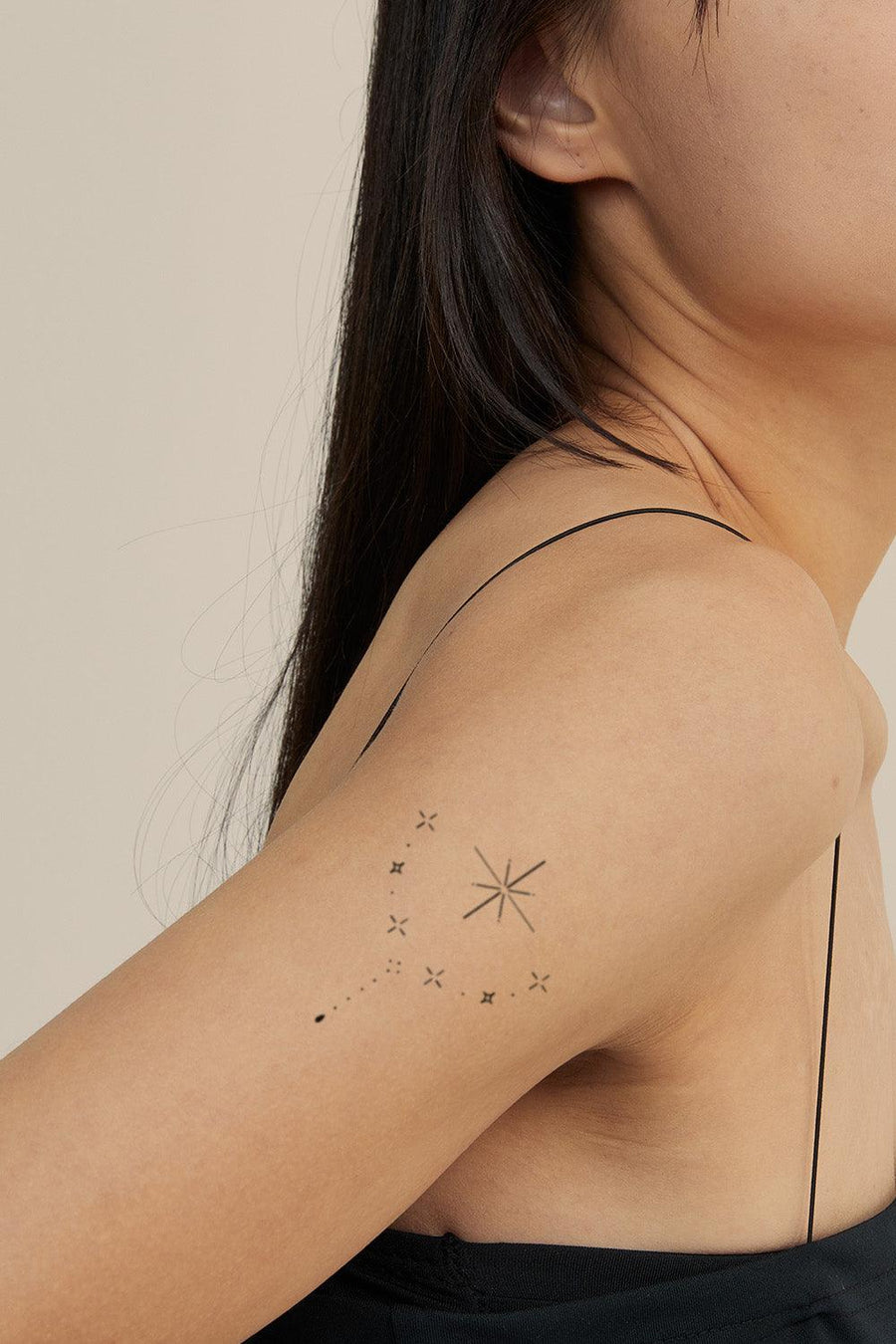 Minimalistic style moon and stars tattoo located on the
